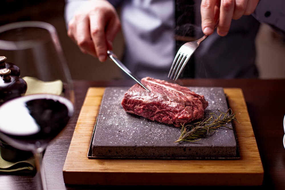 unique places to eat in Wisconsin Dells: photo featuring hot rock cooking steak