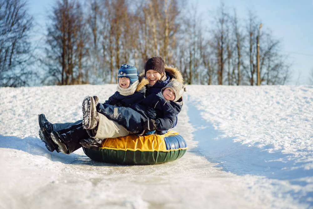 Photo of family snow tubing, one of the most popular Wisconsin Dells winter activities